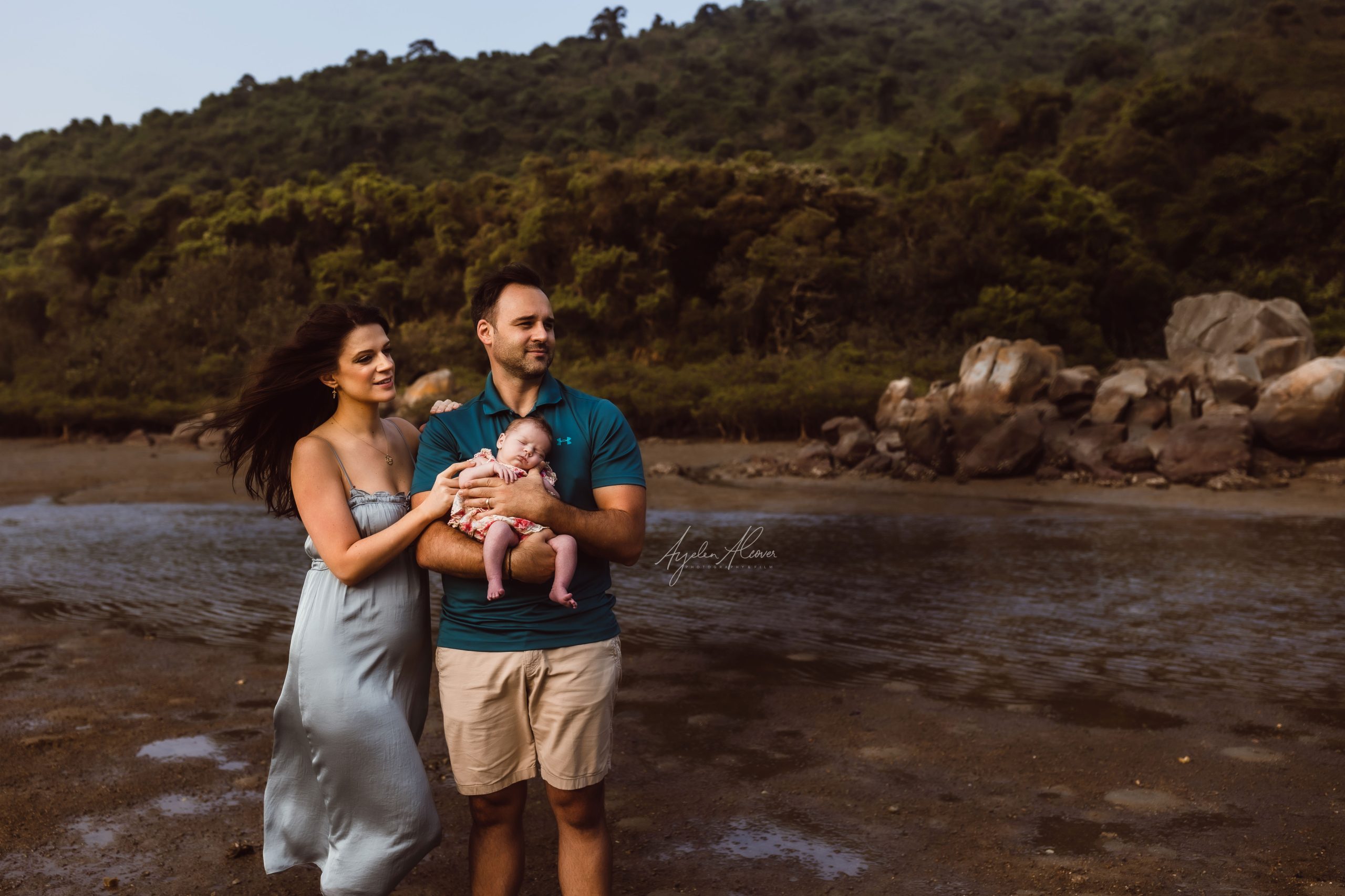 Family of 3 with a newborn baby being photograph outdoor