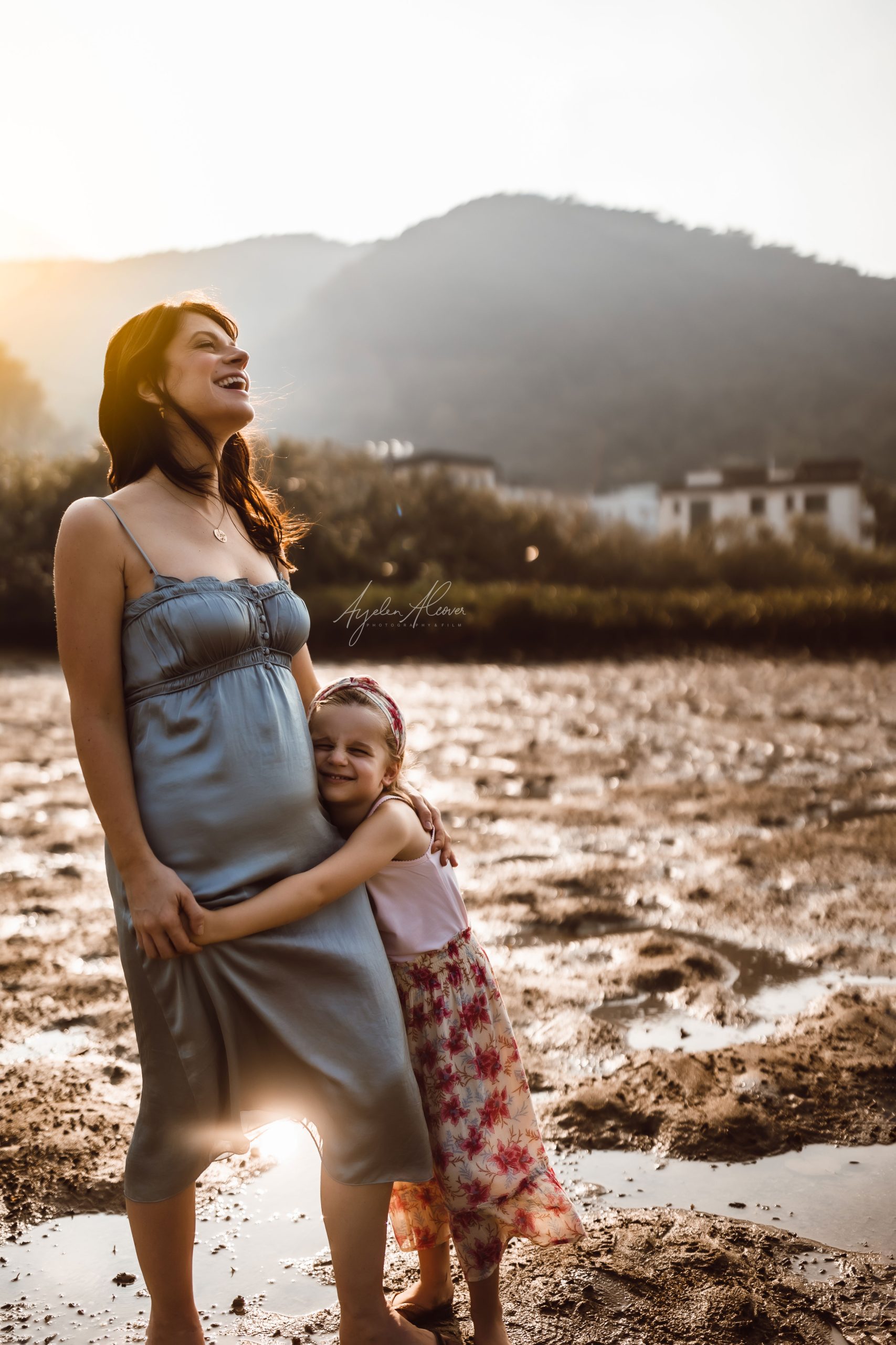 Beautiful mother and daughter laughing with joy on the Golden Hour.