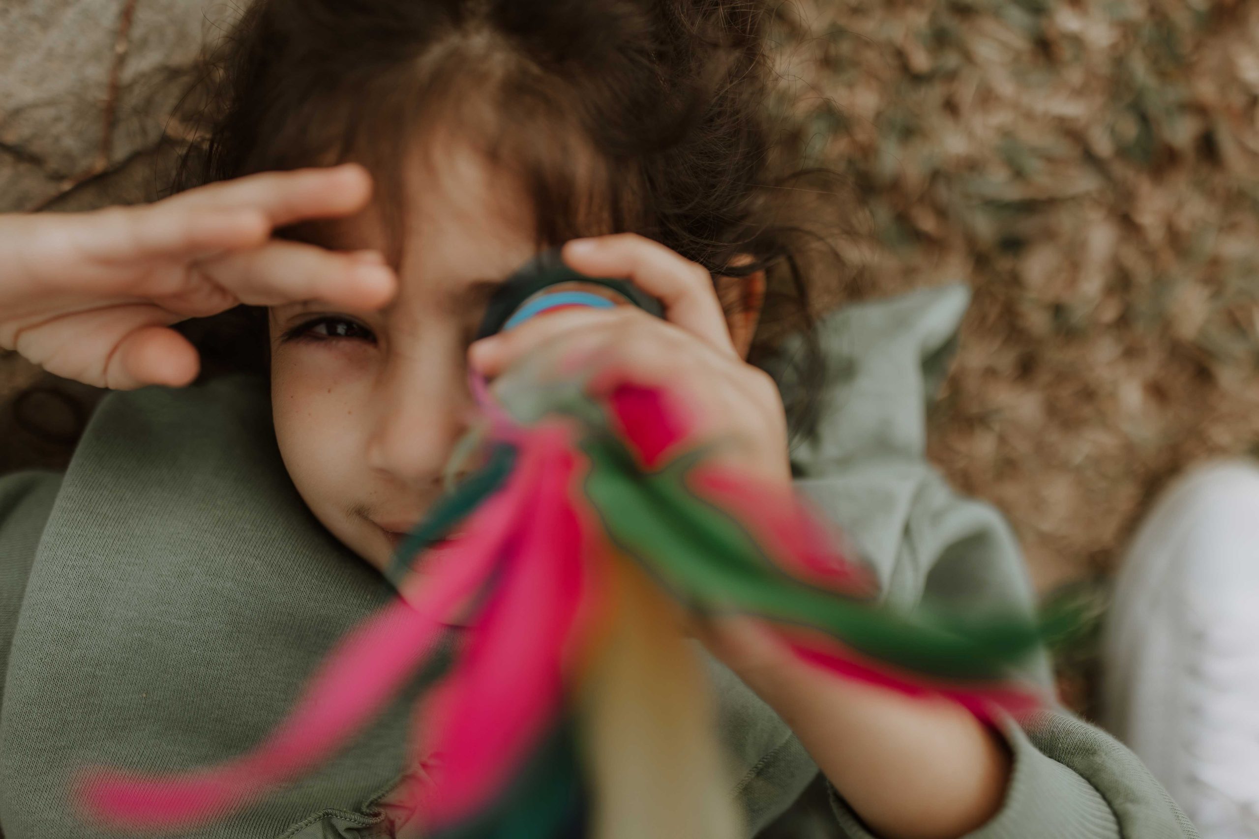 A girl playing with a colorful prop